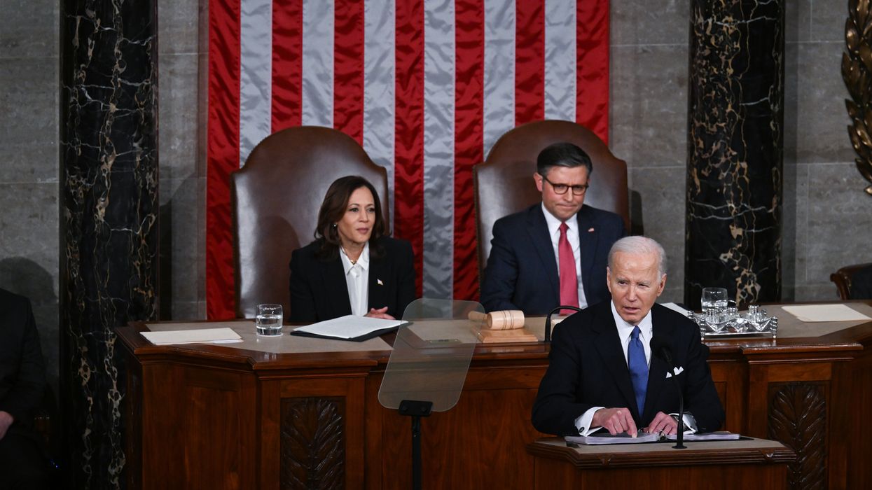 President Biden speaking in the House chamber, with Vice President Kamala Harris and Speaker Mike Johnson behind him