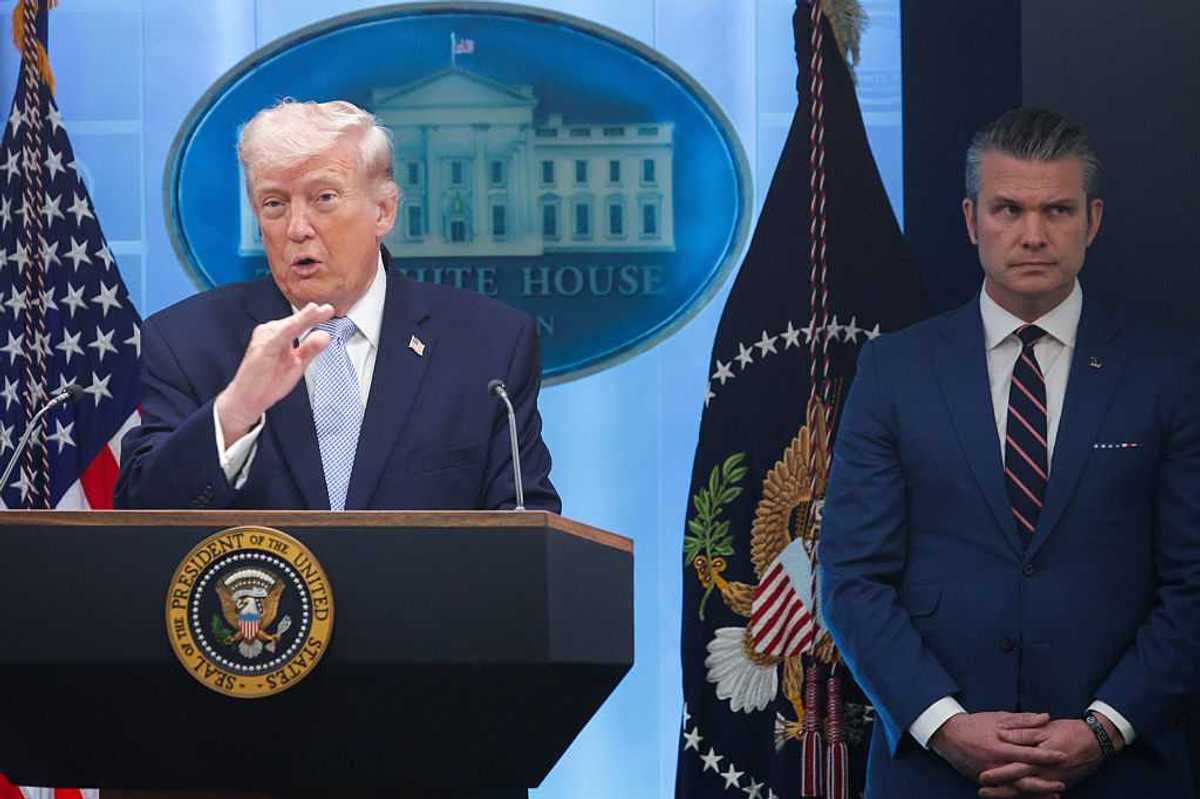 President Trump and U.S. Secretary of War Pete Hegseth standing next to each other at a news conference.