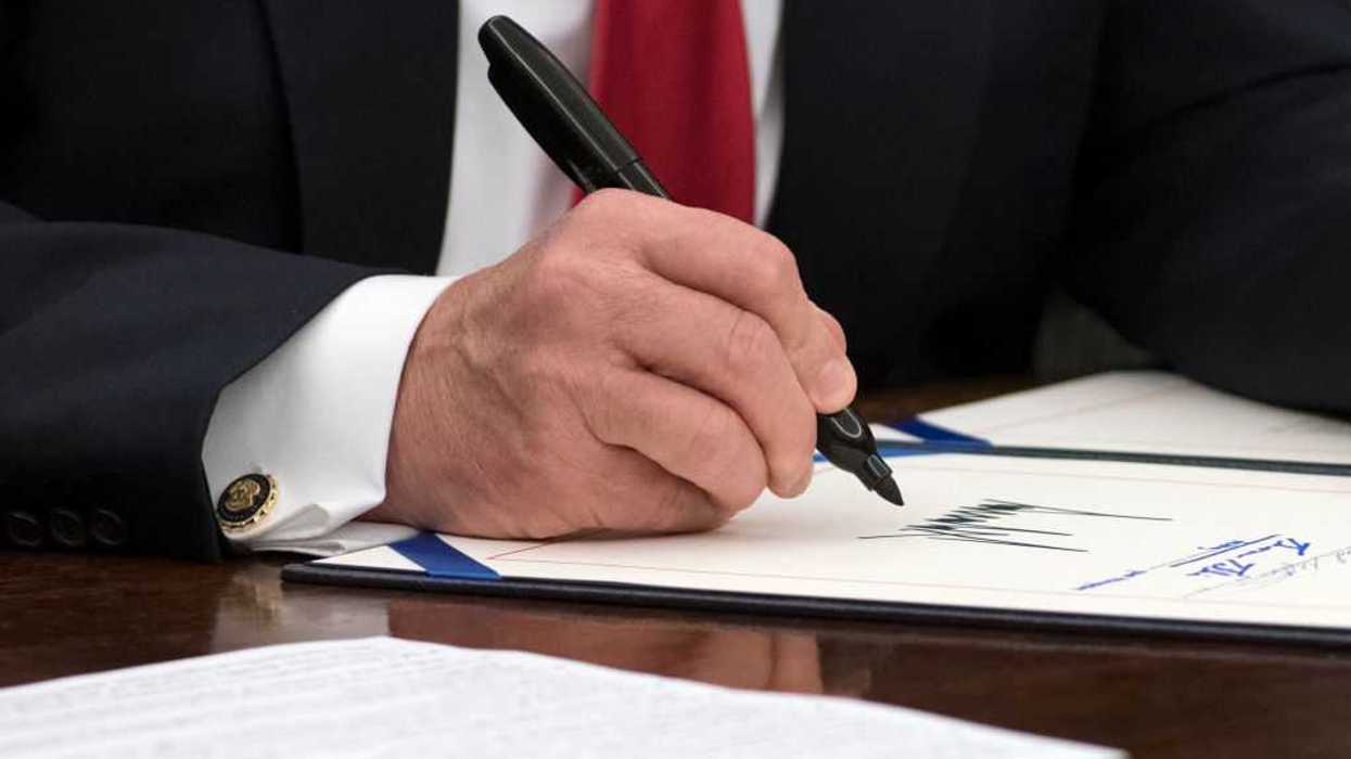 President Trump signing a bill into law.