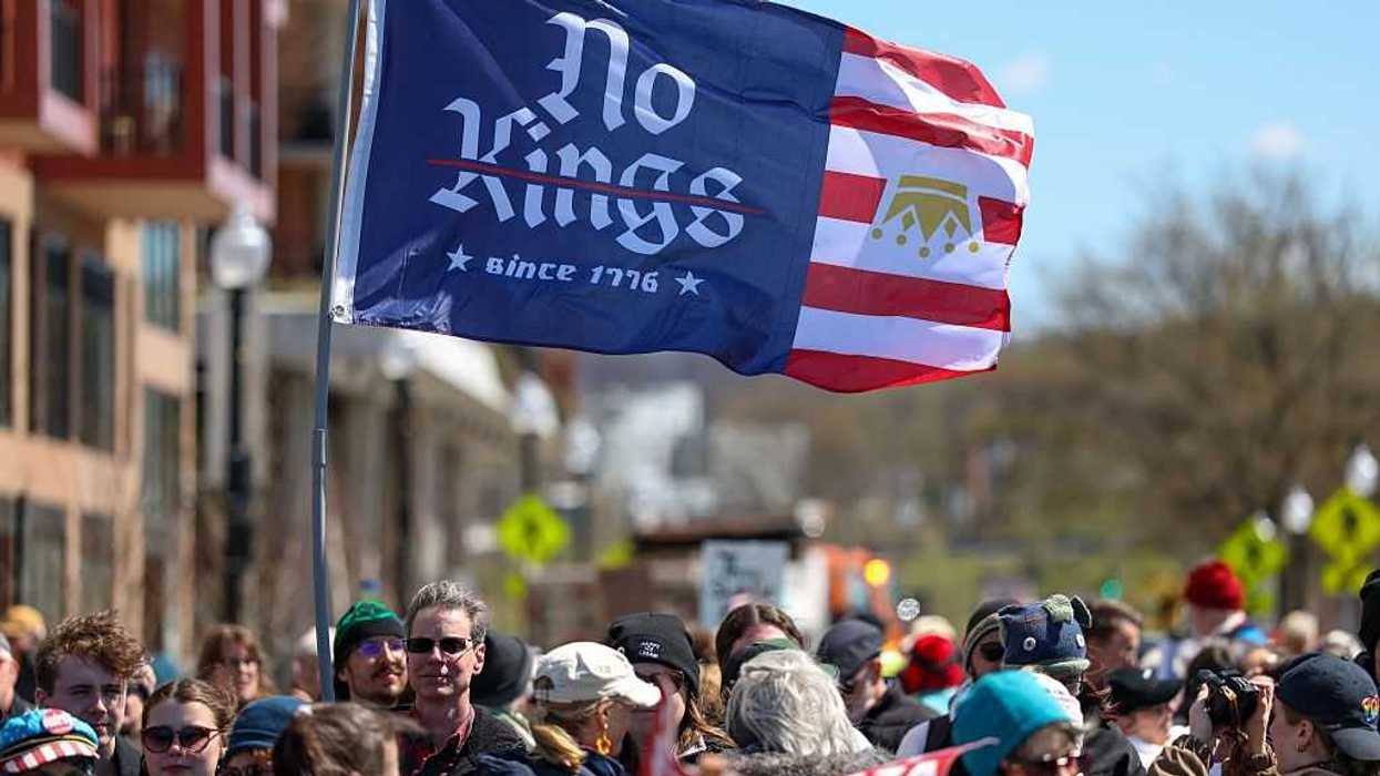 Protestors holding a sign that reads, "No Kings since 1776."