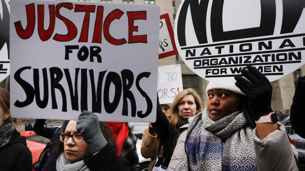 Protestors outside, holding signs that read, "Justice for survivors" and "National Organization for Women."