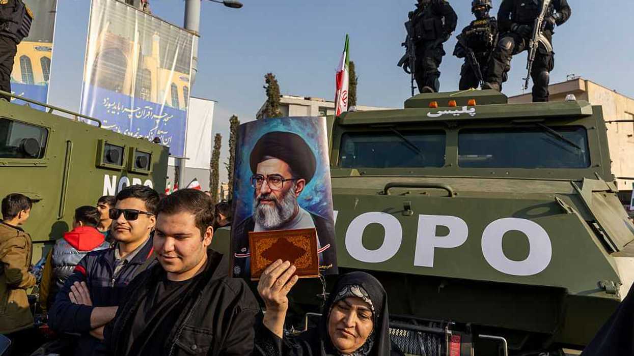 Protestors standing in front of government military tanks.