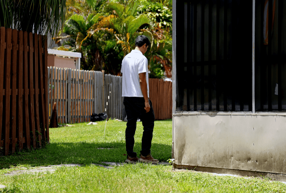 Rafael Rodriguez, a TPS recipient, stands outside of his home