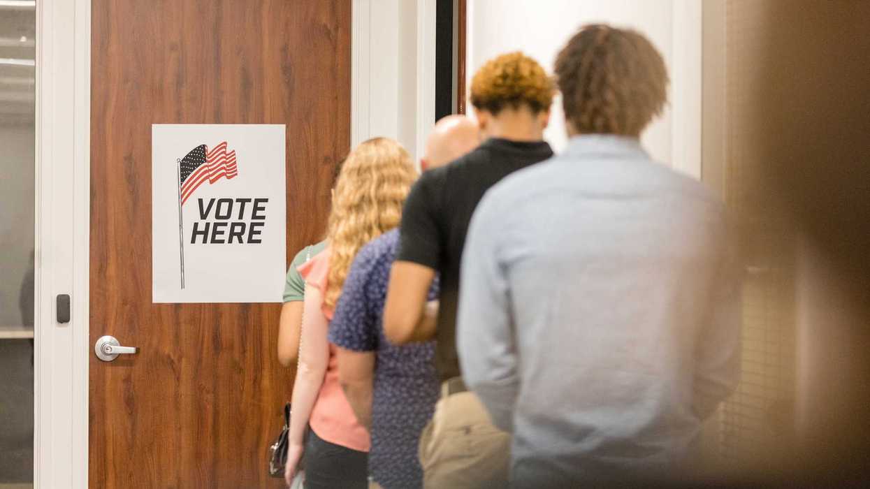 Rear view of long line of unrecognizable diverse voters