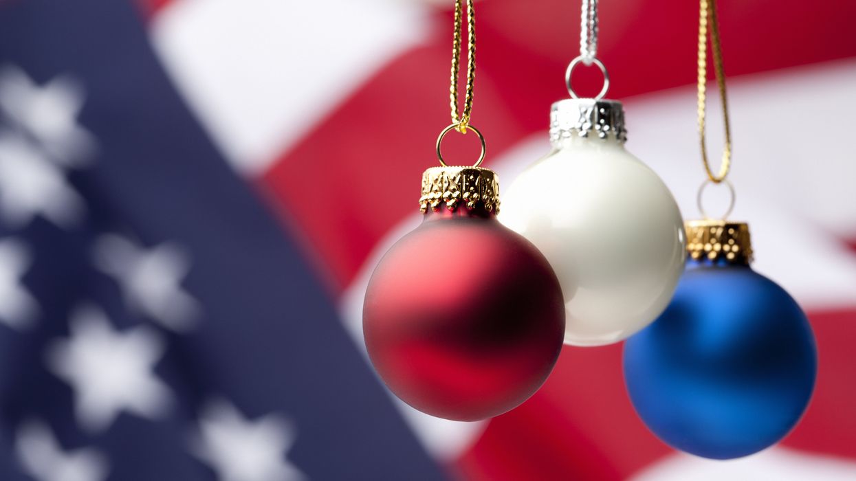Red, white and blue Christmas ornaments with American flag background