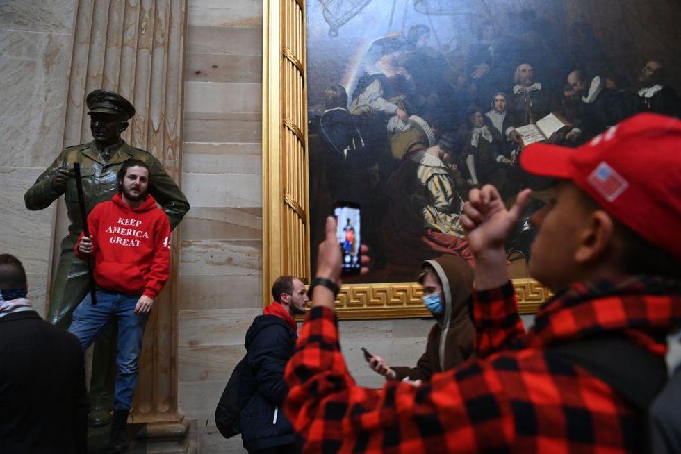 rioter in rotunda at Eisenshower statue