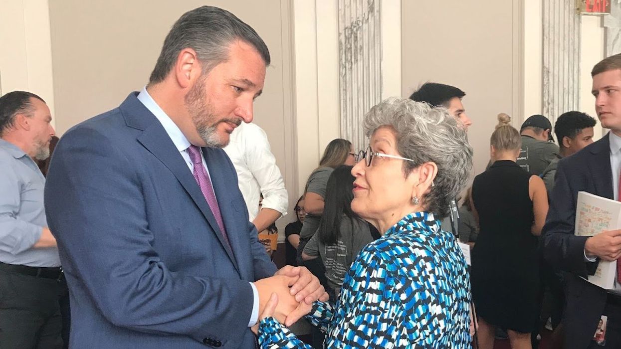 Sen. Ted Cruz and a woman holding hands while speaking