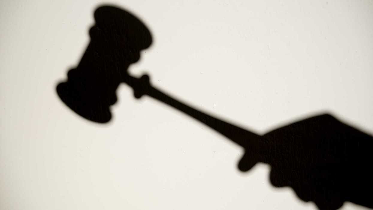 Shadow on a wall of Judge hitting gavel in court, concept of justice, law, and legal protection