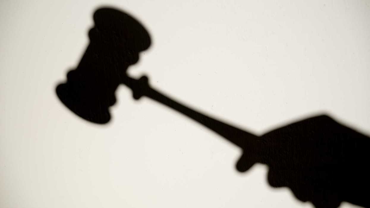 Shadow on a wall of Judge hitting gavel in court, concept of justice, law, and legal protection