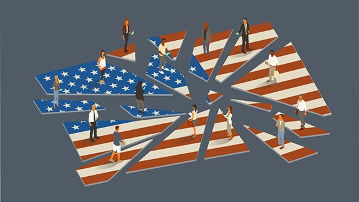 Shattered American flag with people standing on the pieces