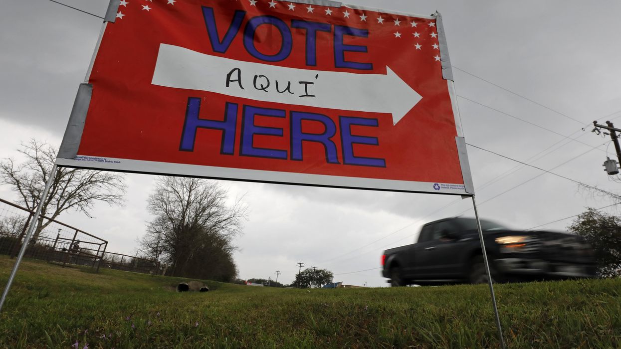 Sign saying "vote" here in two languages