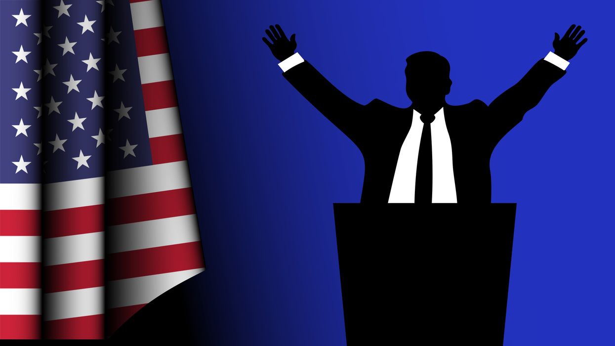 Silhouette of an American Democratic politician speaks to his constituents, with the country's flag on the left