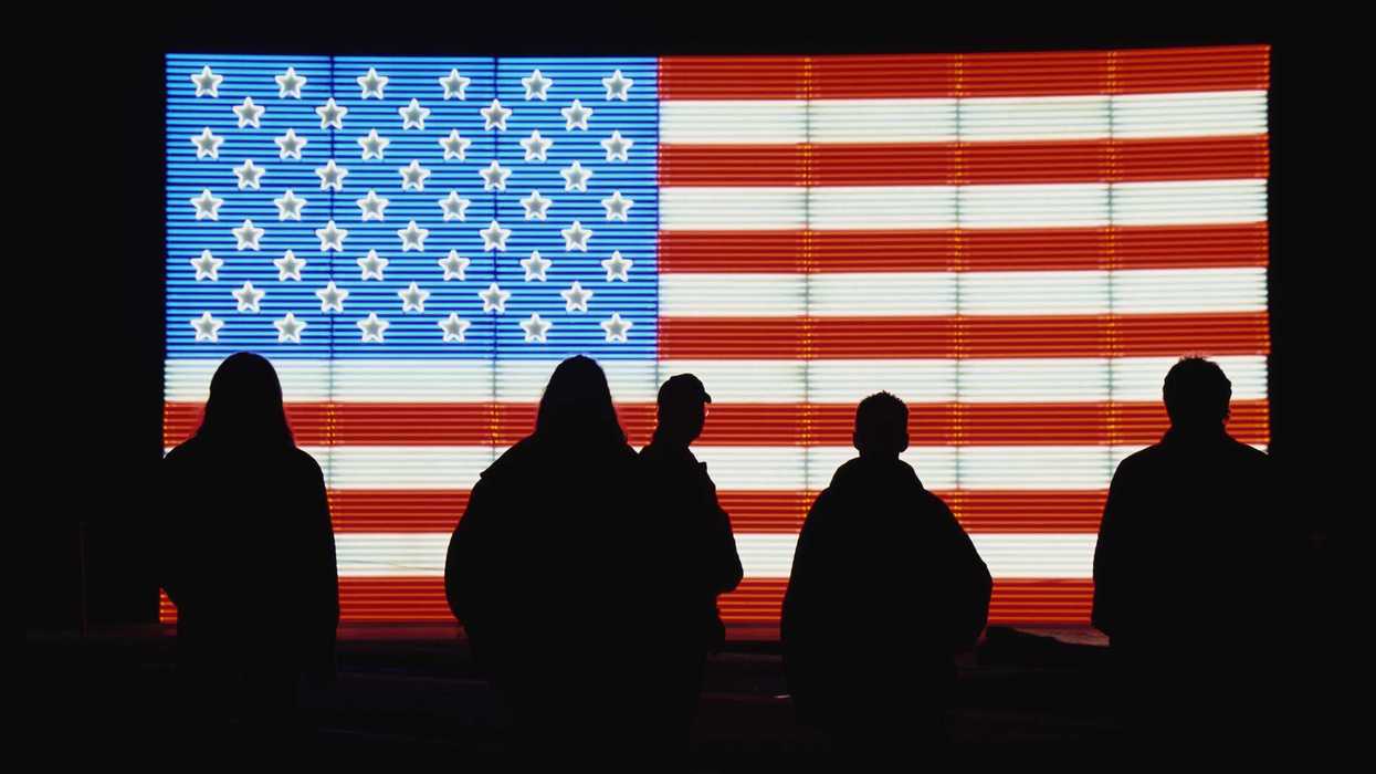 Silhouetted People with American Flag Neon Sign