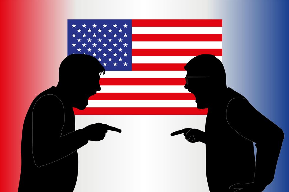 silhouettes of people arguing in front of an America flag