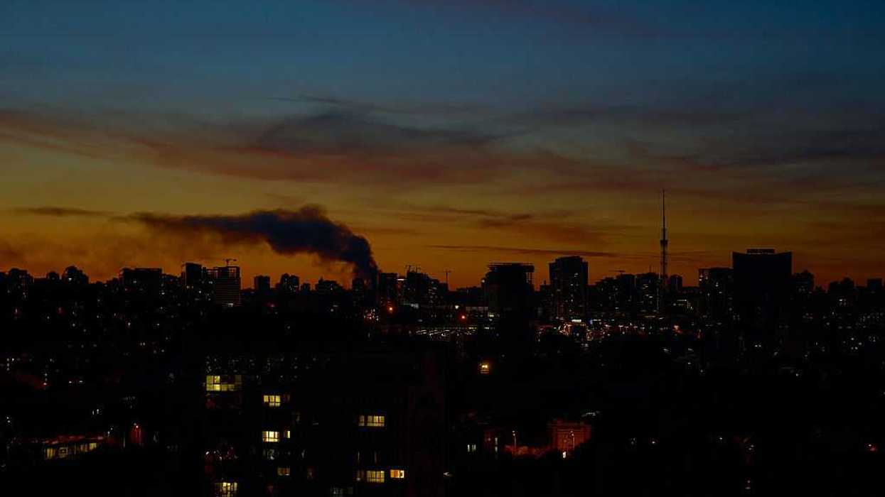 Smoke hangs over the city against a twilight sky following an explosion during an air raid alert on October 2, 2026 in Kyiv, Ukraine