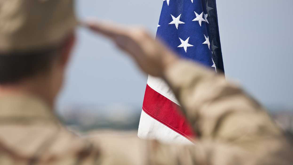 Soldier saluting an American flag