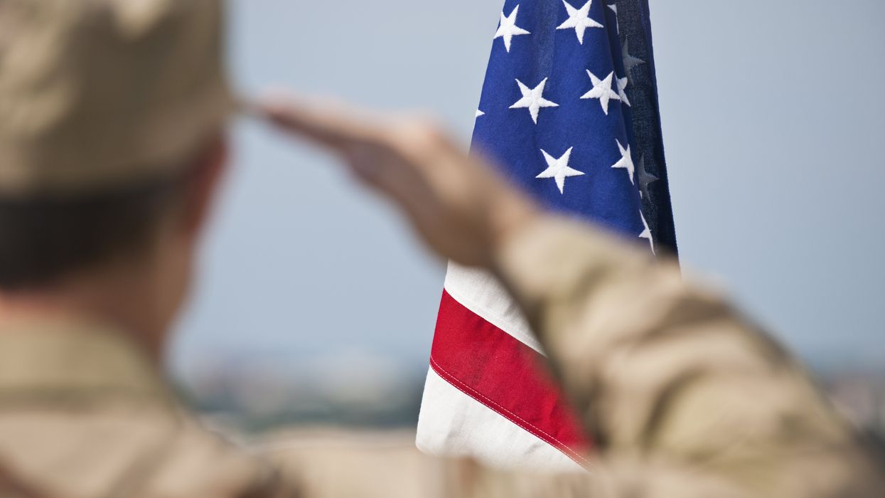 Soldier saluting an American flag