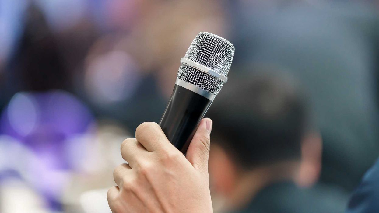 Someone holding a microphone.