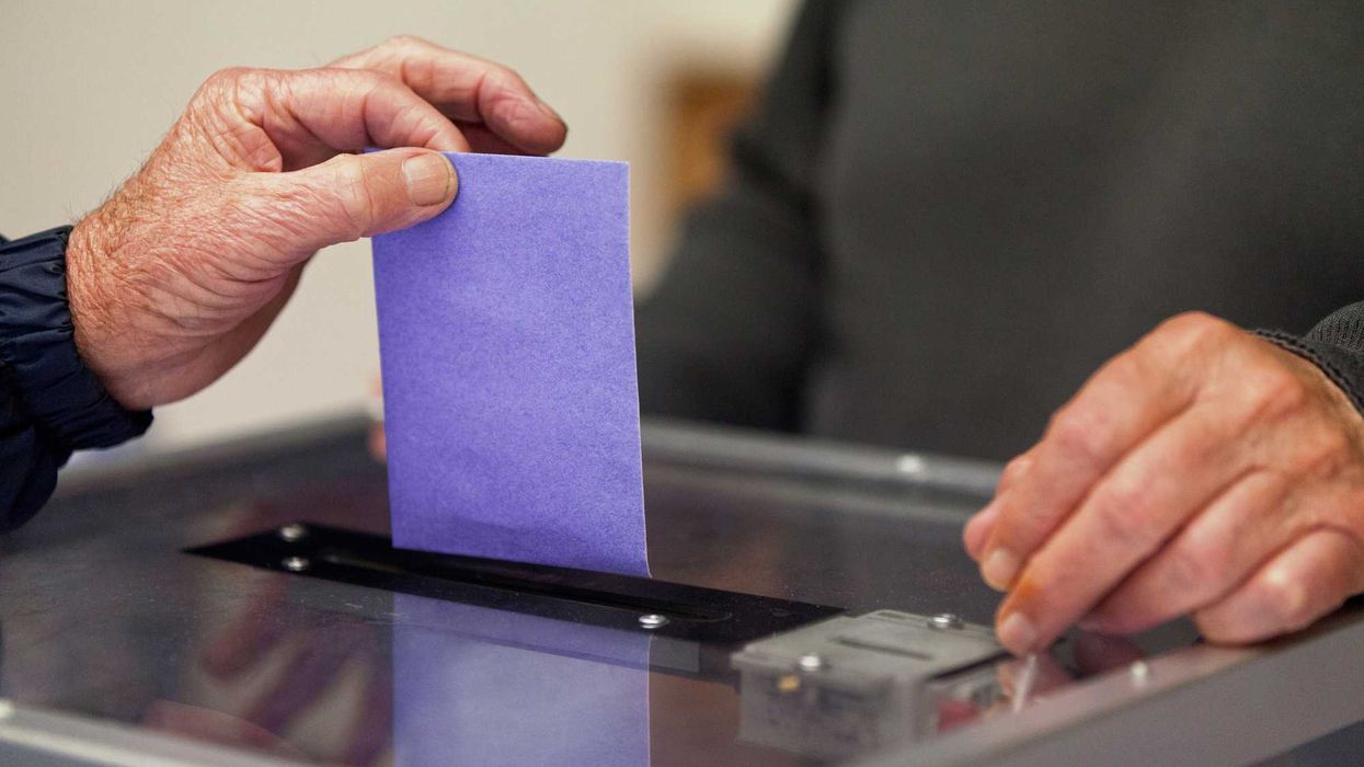 Someone submitting a purple ballot.