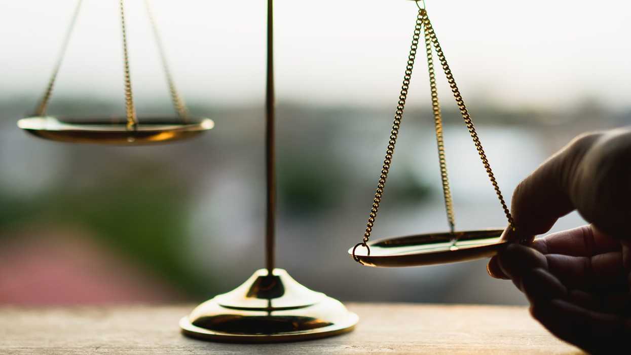 Someone tipping the scales of justice.
