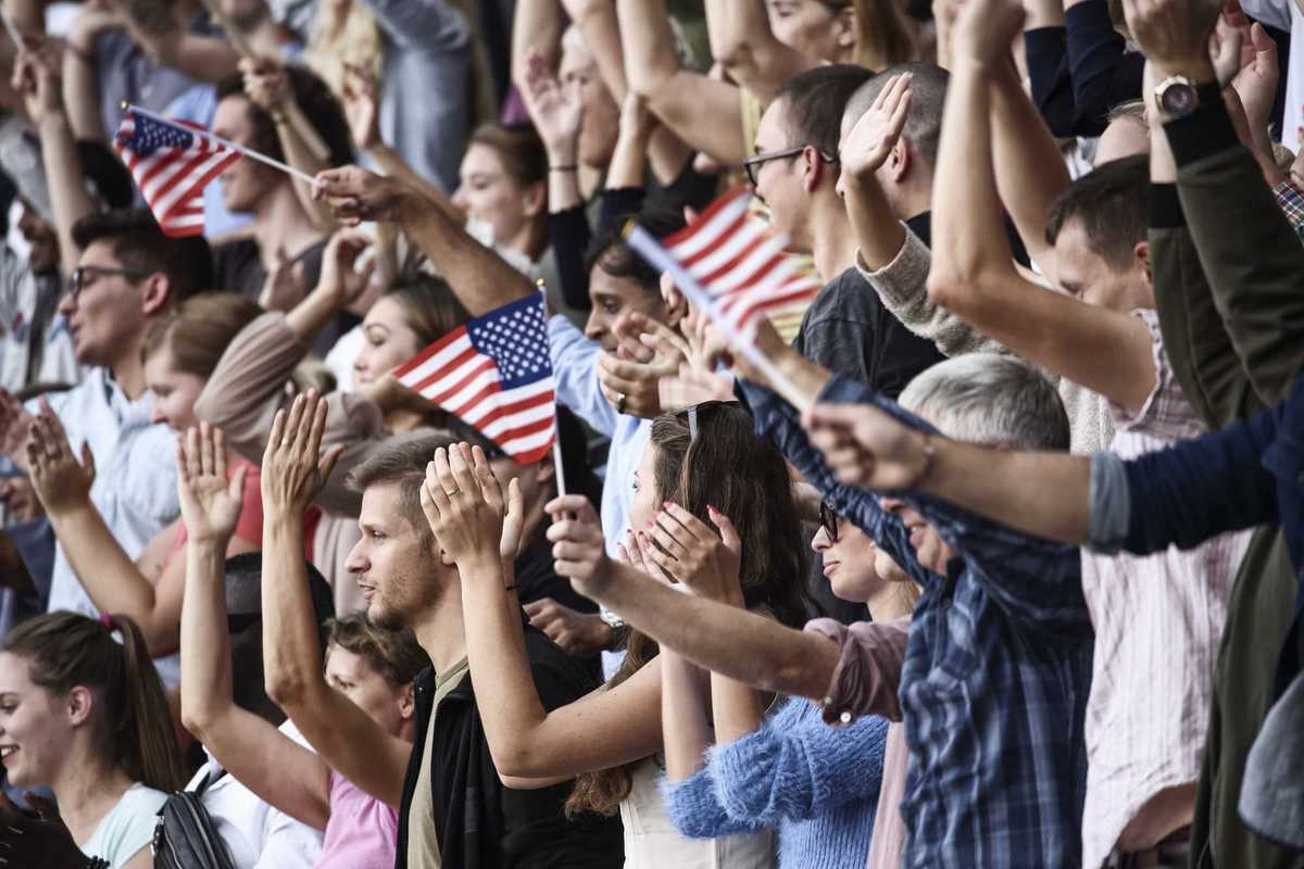 Spectators on a stadium with USA playing.