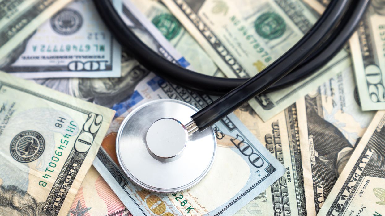 Stethoscope lying on a pile of money