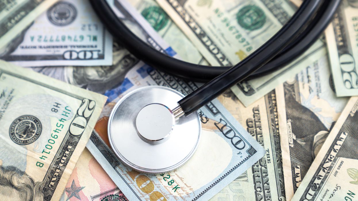 Stethoscope lying on a pile of money
