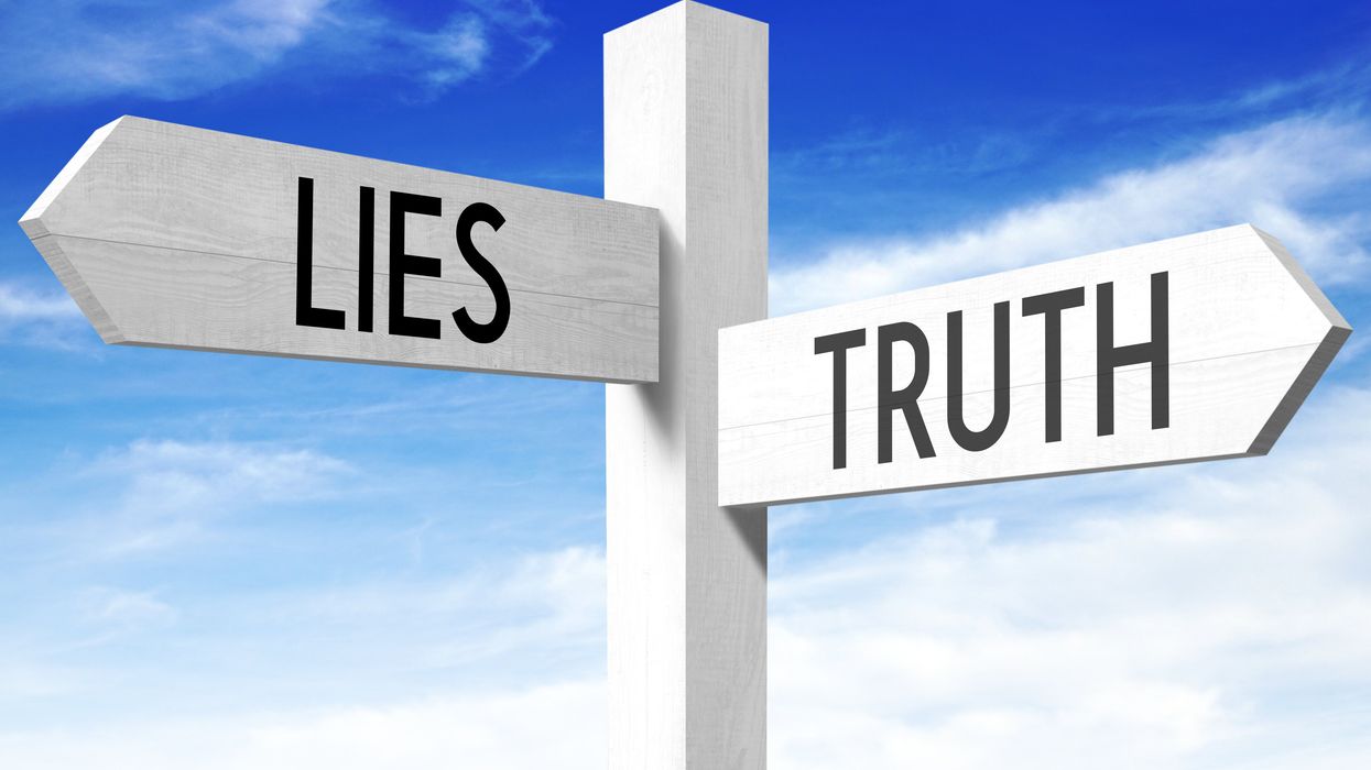 Street signs pointing to lies and truth