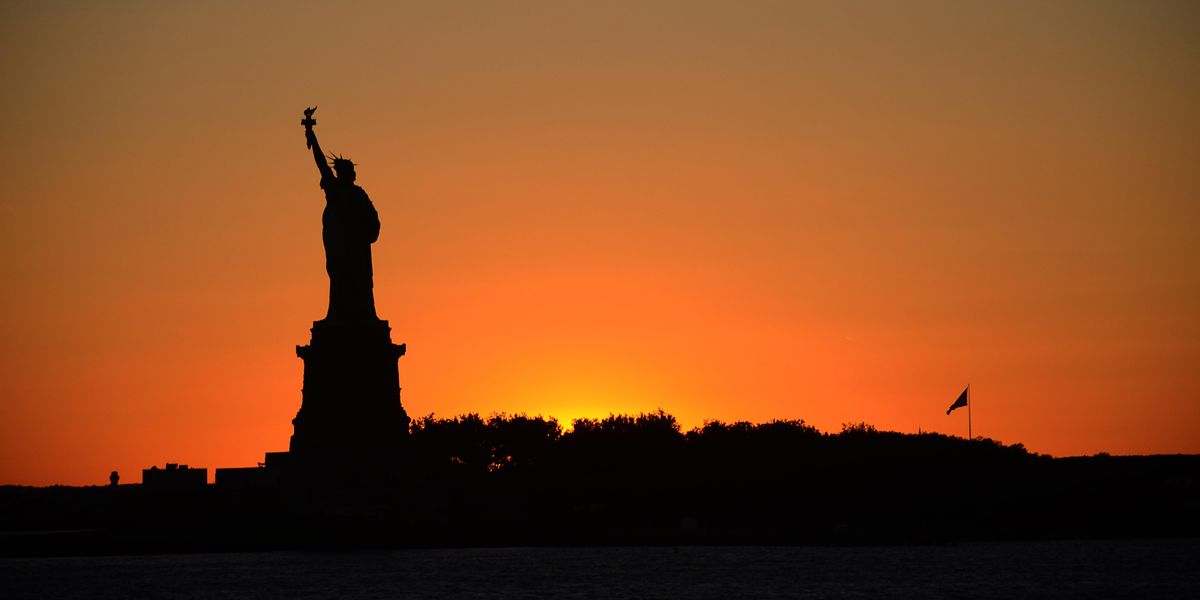 Sunrise behind the Statue of Liberty
