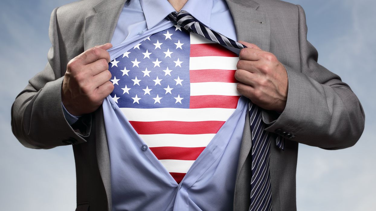 Superhero businessman revealing American flag