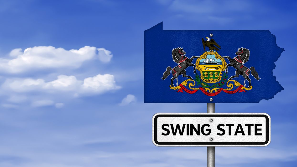 "Swing state" sign under a cutout of Pennsylvania