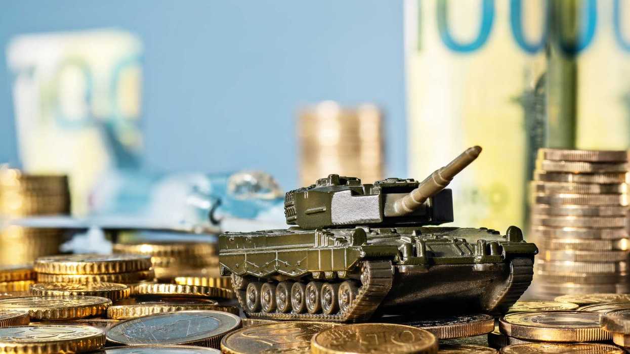 Tank and fighter plane with lots of coins and banknotes.