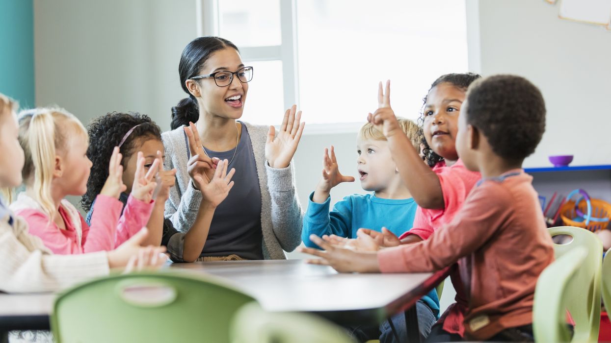 Teacher working with children