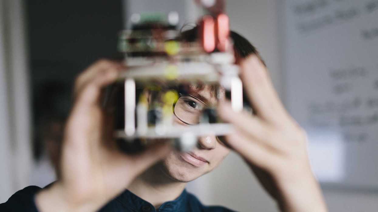 Teenager admiring electronic hobby robot.
