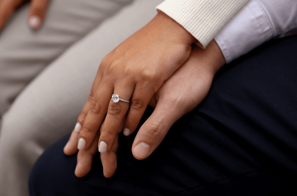 Temporary Protected Status recipient Mariana rests her hand on fiance Antonio\u2019s hand 