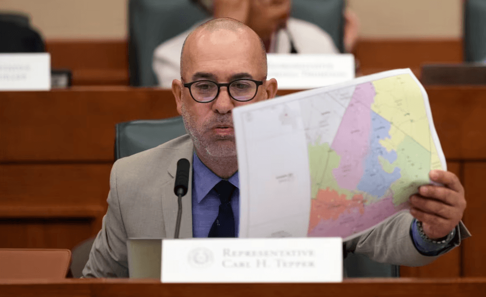 Texas state legislator Carl Tepper examines a congressional district map