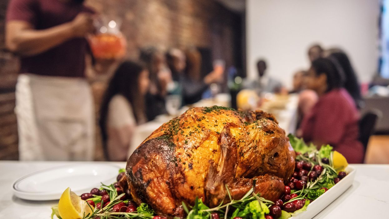 Thanksgiving turkey with family in the background
