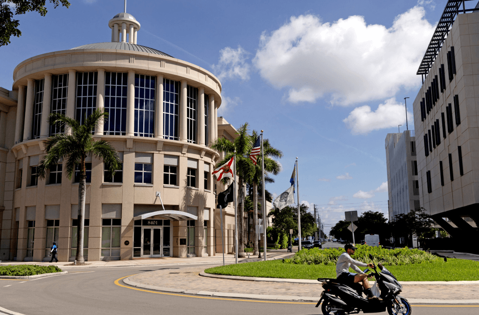 The Florida and American flags fly outside the Doral Government Center in Doral, Florida