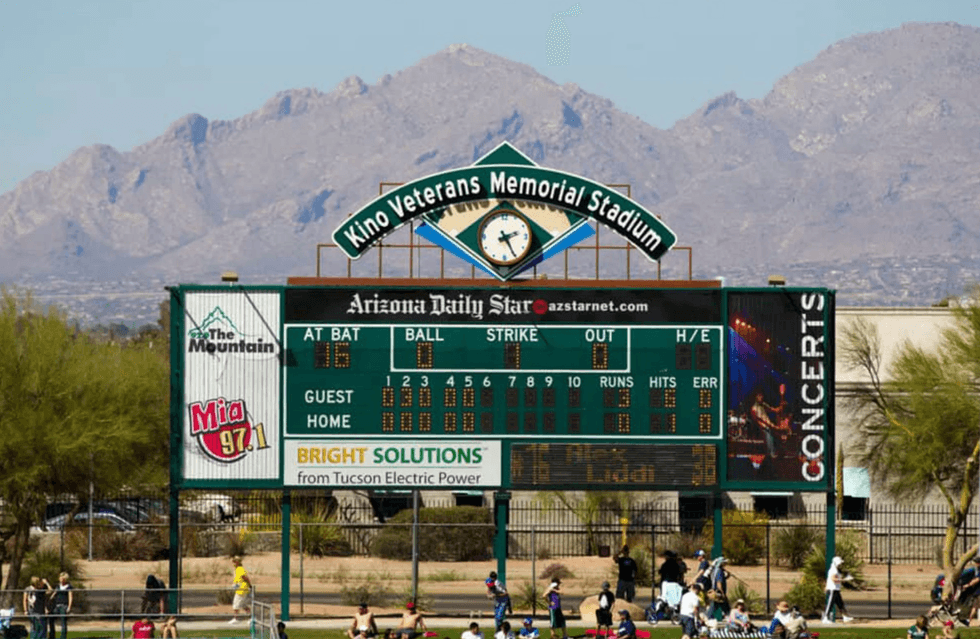 The Santa Catalina Mountains rise behind the scoreboard