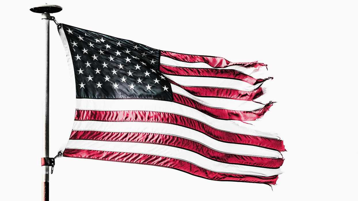 The U.S. flag, waving, with the ends of it frayed.