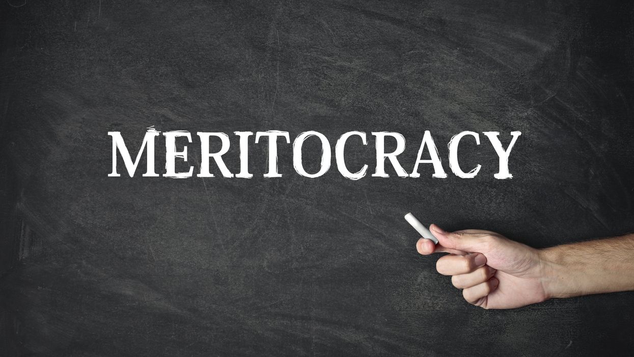 The word "meritocracy" on a chalkboard