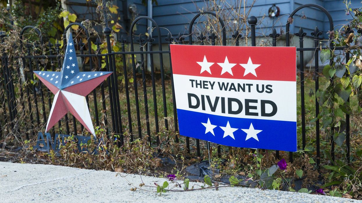 "They want us divided sign" that represents partisanship among democrats and republicans.