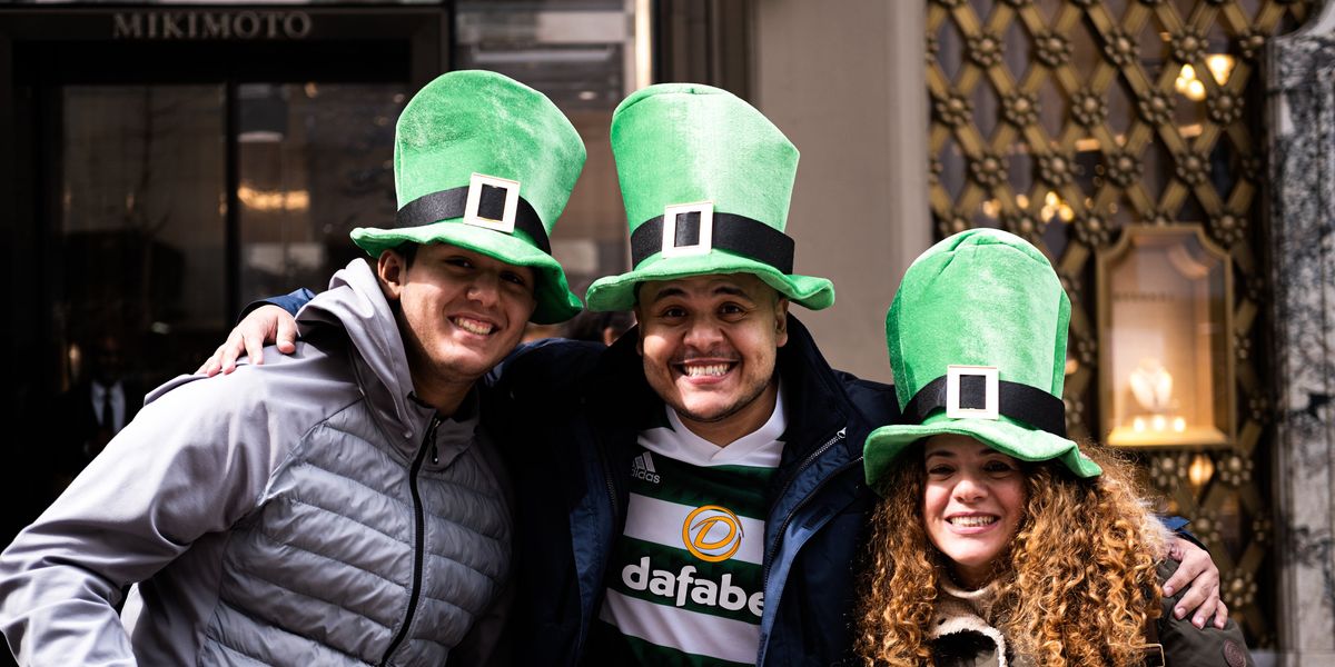three people wearing green top hats