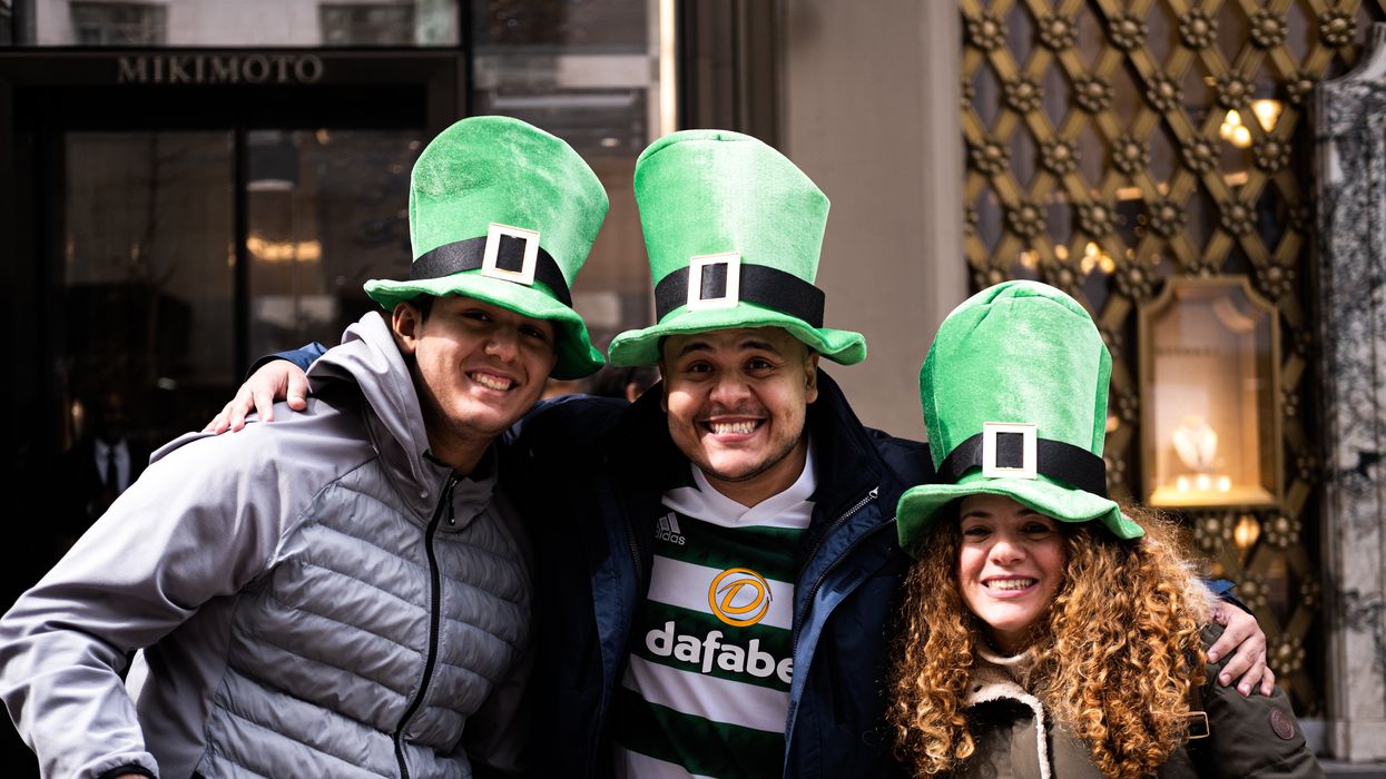 three people wearing green top hats