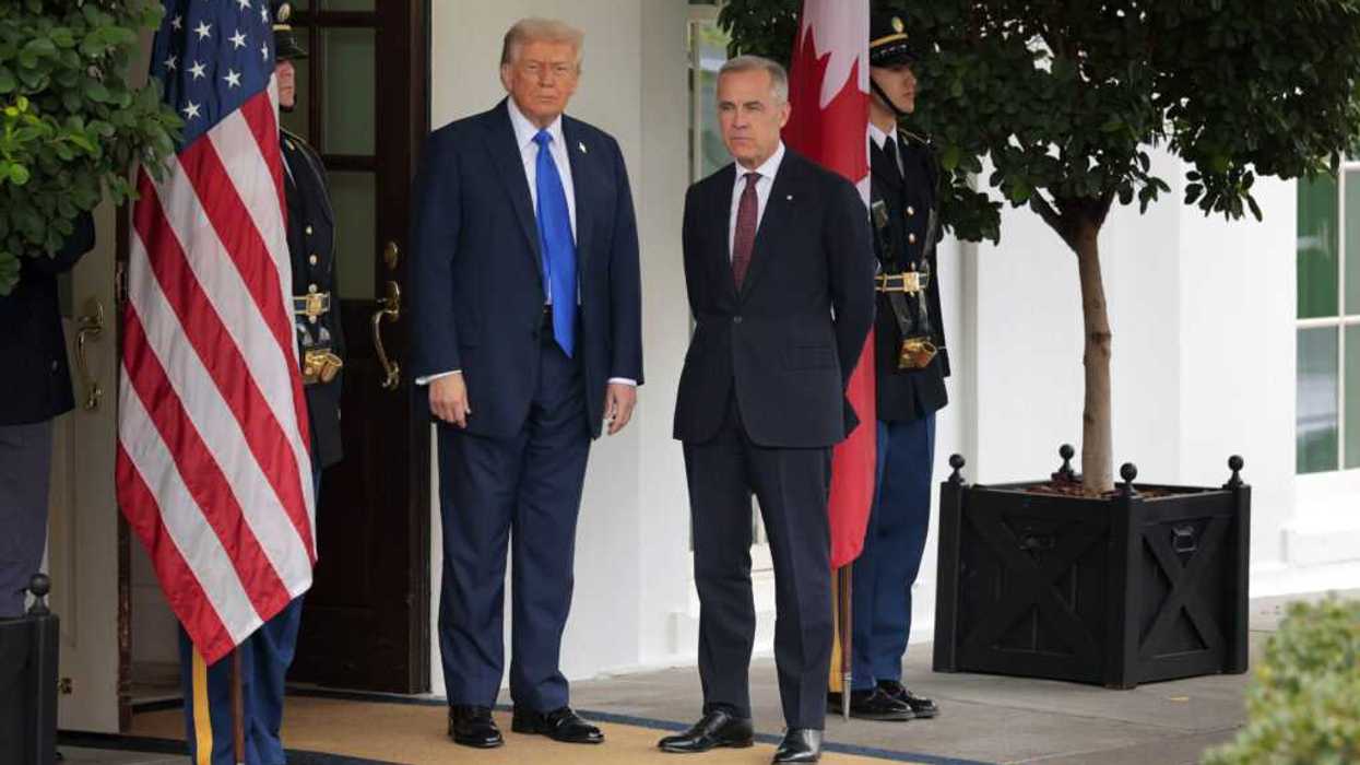 Trump and Carney standing next to American flag