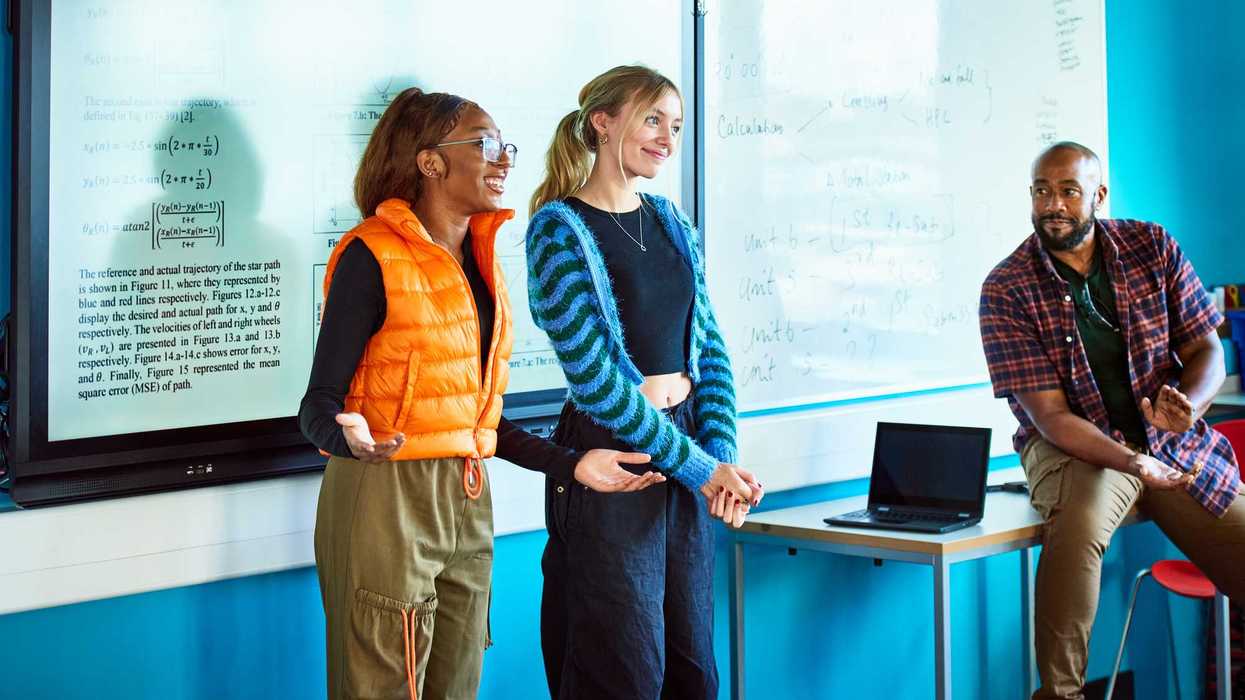 Two college students presenting project to class