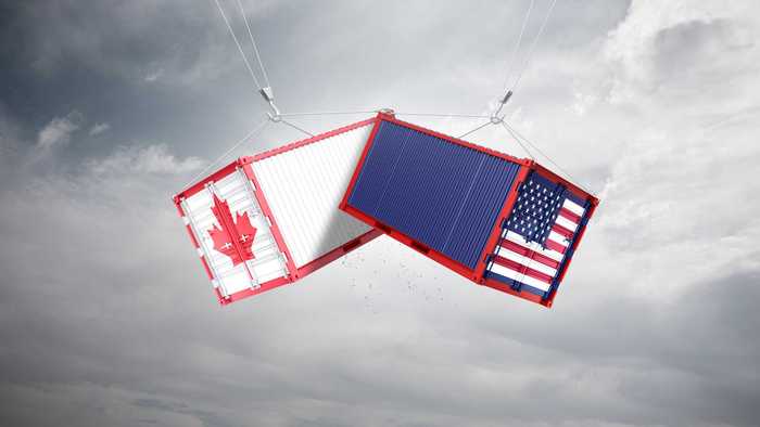 Two containers, one with a U.S. flag and another with Canada's flag.