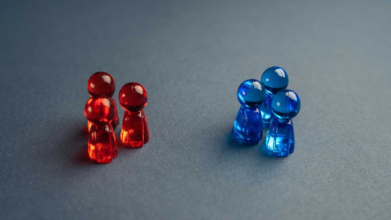 Two groups of glass figures. One red, one blue.