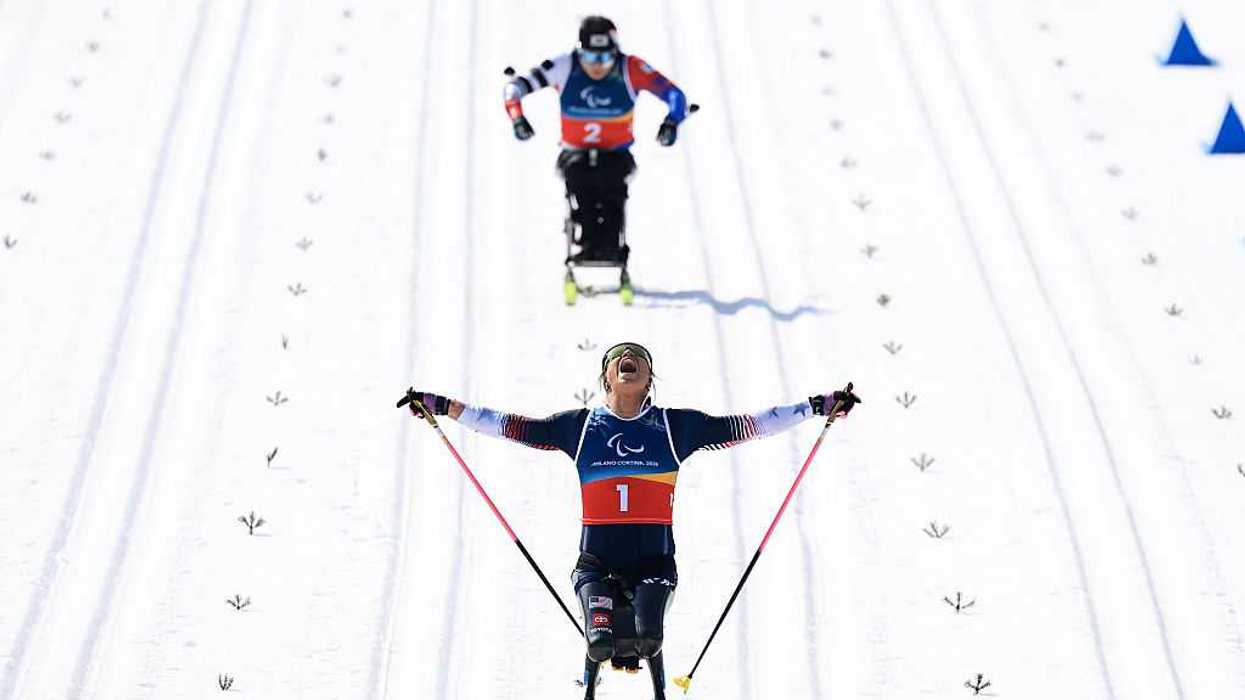 Two individuals Skiing in the Milano Cortina 2026 Winter Paralympic Games.
