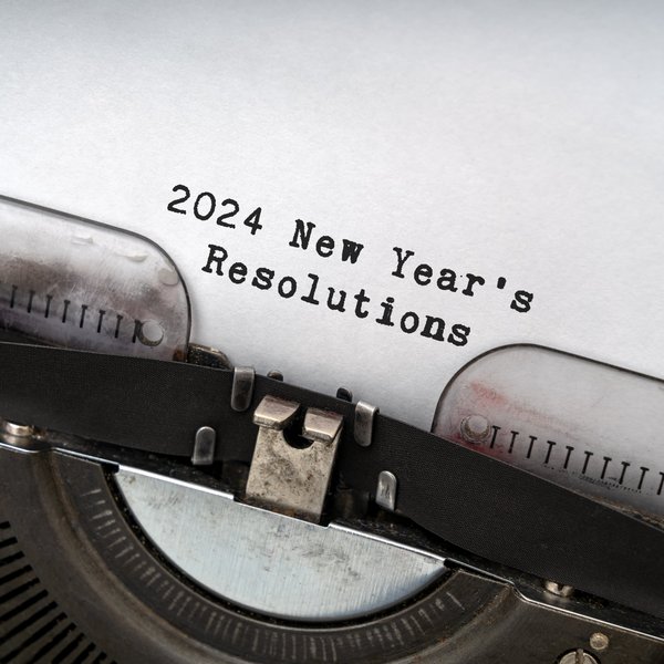 Typewriter with paper that reads "2024 New Year's Resolutions"